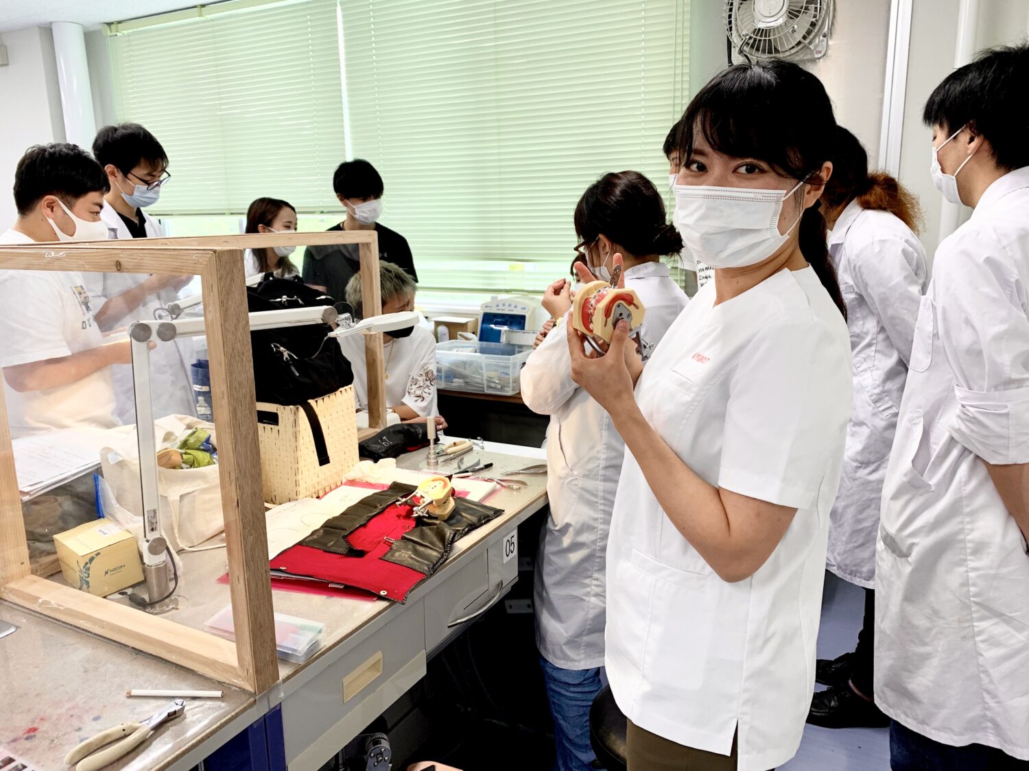 矯正歯科の実技実習を指導している様子。コロナ禍なので、パーテーションがされています。
